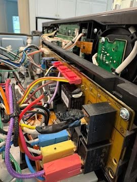 Oven control board and wiring harness exposed for diagnostic testing